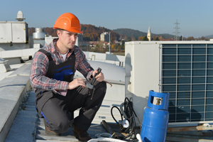 Man Repairing Rooftop AC