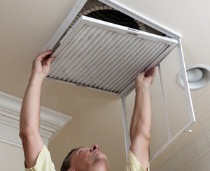 depositphotos_11461285-Senior-man-opening-air-conditioning-filter-in-ceiling-300x245