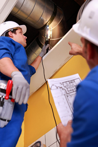 Workers Inspecting Ventilation System